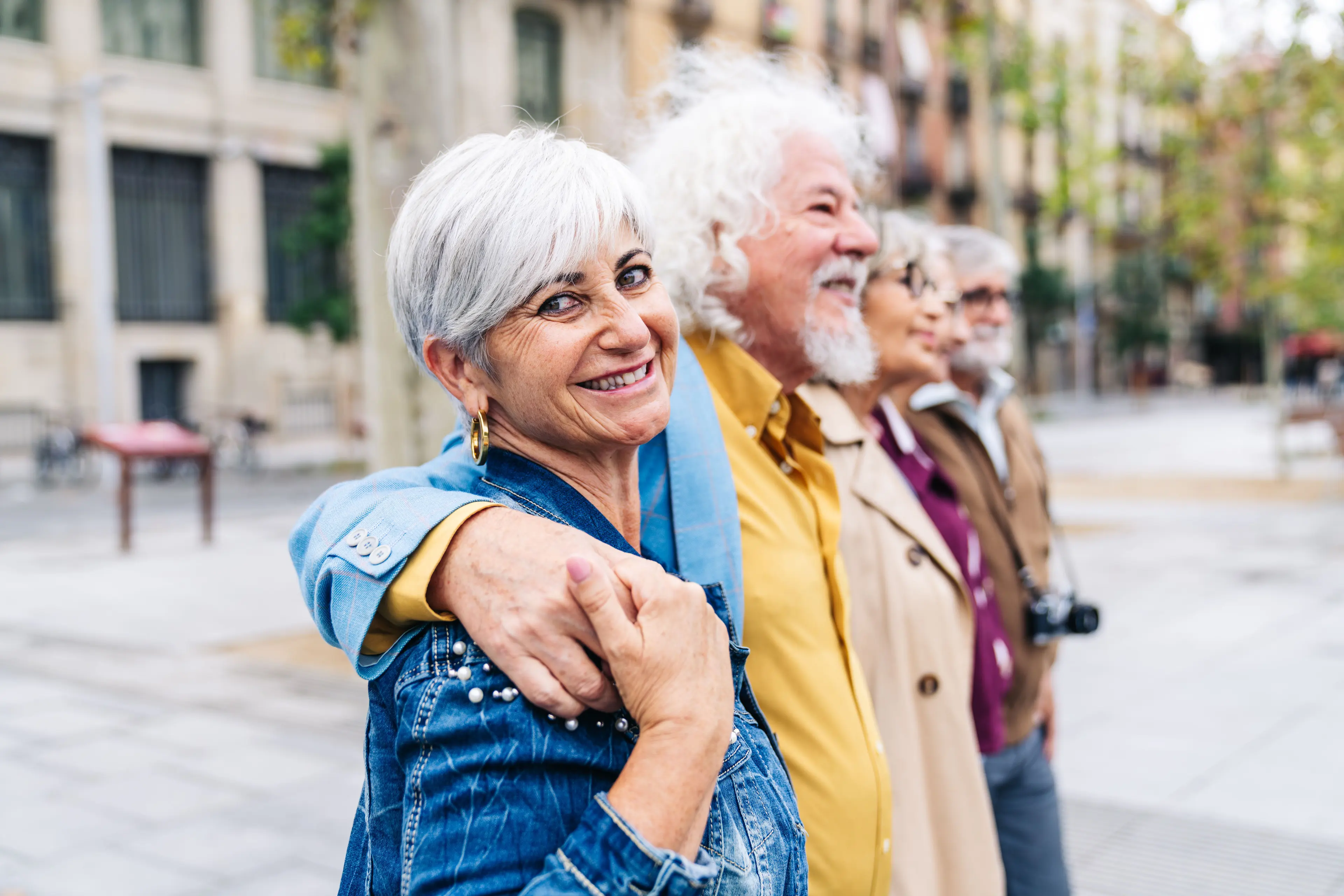 A diverse group of older adults walking together outdoors 